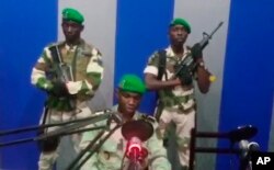 In this image from TV, a soldier who identified himself as Lt. Obiang Ondo Kelly, commander of the Republican Guard, reads a statement on state television broadcast from Libreville, saying the military has seized control of the government, Jan. 7, 2019.