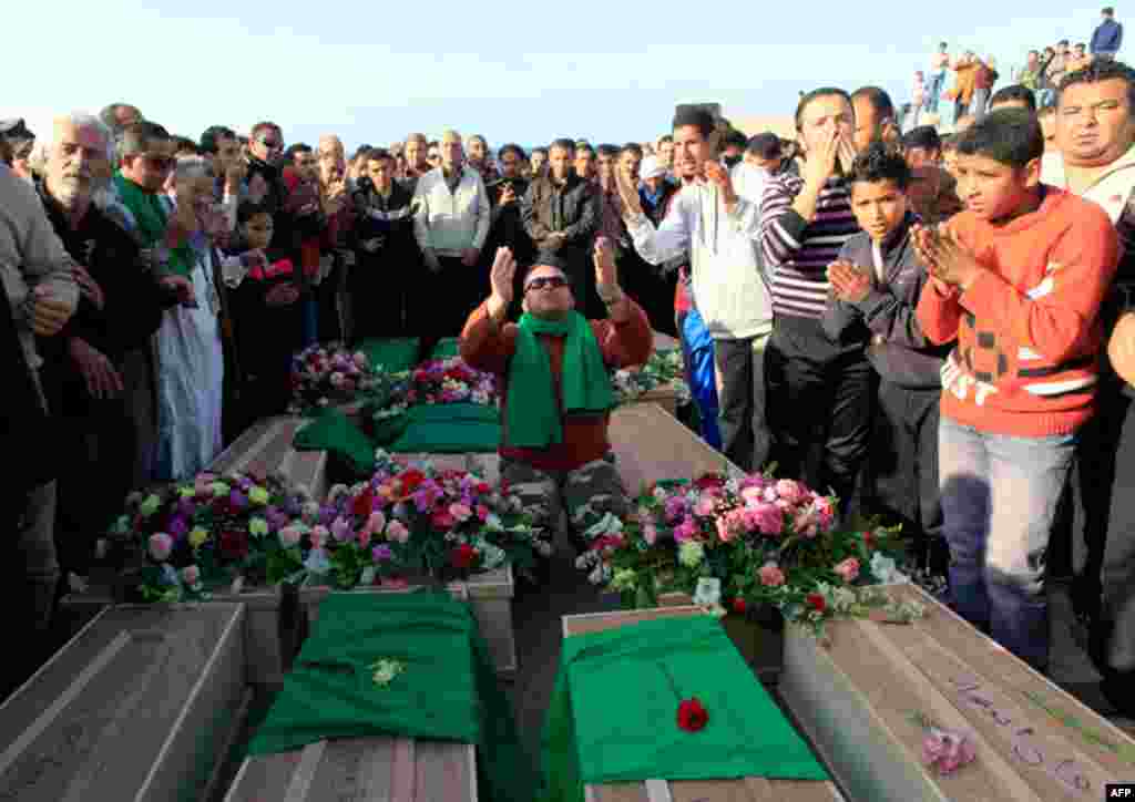 March 24: Mourners attend the funeral of people who were killed after air strikes Wednesday night, at the martyrs' cemetery in Tripoli. (Reuters/Ahmed Jadallah)