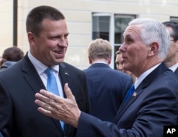 U.S. Vice President Mike Pence, right, and Estonia's Prime Minister Juri Ratas speak prior to their meeting at the Stenbocki house in Tallinn, Estonia, Sunday, July 30, 2017. Pence arrived in Tallinn for a two day visit where he will meet Baltic States leaders.
