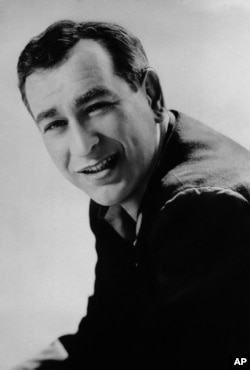 FILE - Shelley Berman, pictured in 1961, was a pioneer of a brand of comedy that could evoke laughter from such matters as air travel discomforts and small children who answer the telephone.