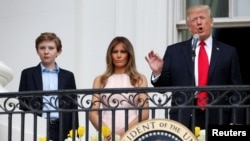 U.S. President Donald Trump speaks as First Lady Melania Trump and their son Barron listen at the 139th annual White House Easter Egg Roll on the South Lawn of the White House in Washington, U.S., April 17, 2017. REUTERS/Joshua Roberts