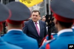 FILE - President of the Bosnian Serb Republic Milorad Dodik inspects an honor guard during a parade in the Bosnian town of Banja Luka, Jan. 9, 2018.