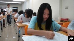 FILE - Junior high students study in a small cram school in hopes of success on their high school entrance exams, in Taipei, Taiwan.