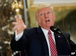 President Donald Trump speaks to the media in the lobby of Trump Tower in New York, Aug. 15, 2017.