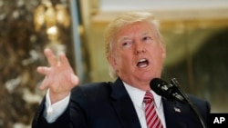 President Donald Trump speaks to the media in the lobby of Trump Tower in New York, Aug. 15, 2017. 