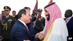Egyptian President Abdel-Fattah el-Sissi, left, greets Saudi Crown Prince Mohammed bin Salman on his arrival to Cairo, Egypt, for a visit meant to deepen the alliance between two of the region's powerhouses, Sunday, March 4, 2018.