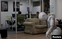 SoftBank's humanoid robots 'Pepper' is seen as students attend Code Chrysalis, a software-coding boot camp, at a basement room in Tokyo, Japan, May 23 2018.