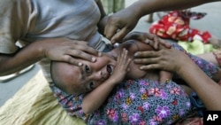 An ethnic Kachin child suffering from malaria receives treatment at a camp for people displaced by fighting between government troops and the Kachin Independence Army in northern Burma, February 22, 2012.