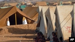 FILE - Displaced Yemeni women from the Saada province sit outside a tent at the Mazraq Internally Displaced People's (IDP) camp in northern Yemen.