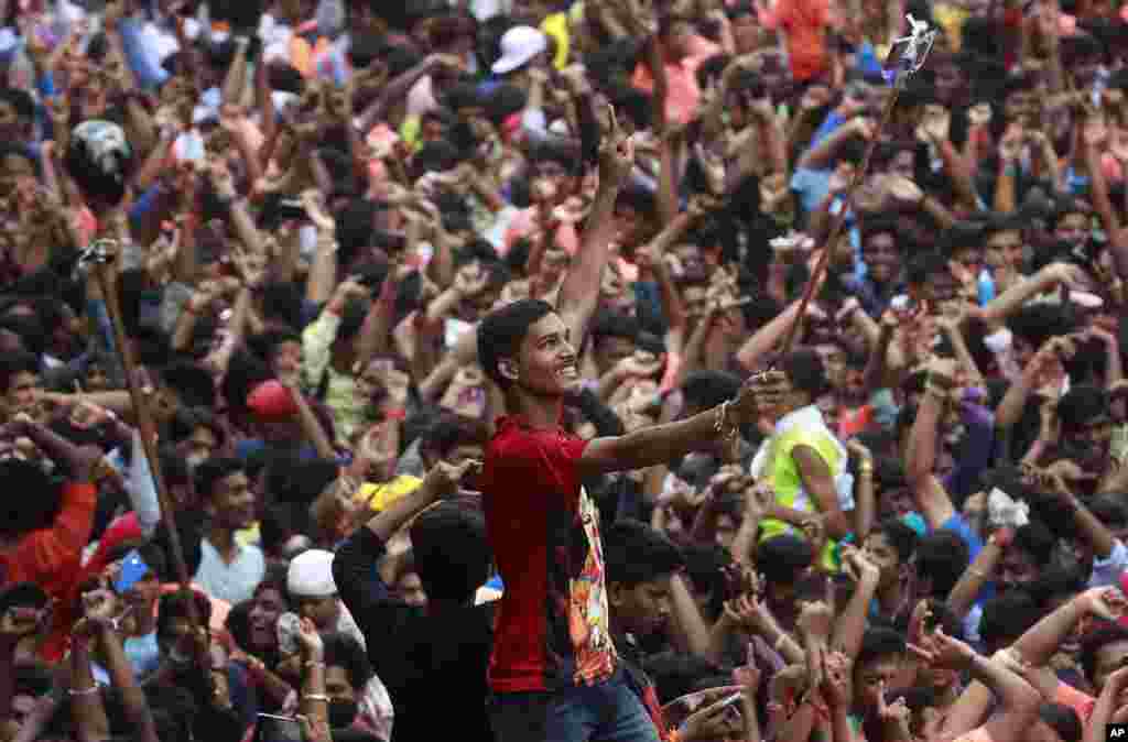 A devotee takes a selfie during a procession of elephant headed Hindu god Ganesh in Mumbai, India.