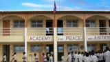 Children walk across the schoolyard of the Academy for Peace and Justice, run by a Catholic priest, in Port-au-Prince January 9, 2012. Bankrolled by a roster of Hollywood celebrities, the Academy of Peace and Justice is Haiti's first free secondary school