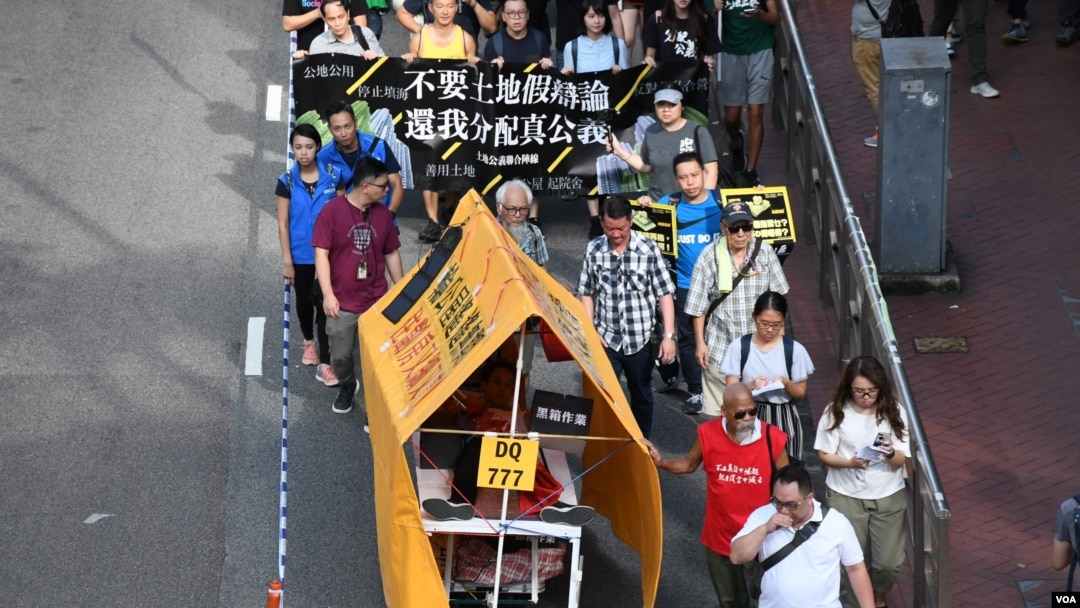 遊行人士製作”流動劏房車”反映住劏房又貴又細的苦況。(美國之音湯惠芸)