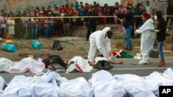 Bodies in body bags are placed on the side of the road after an accident in Tuxtla Gutierrez, Chiapas state, Mexico, Dec. 9, 2021.