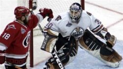 **CORRECTS BYLINE**Carolina Hurricanes' Mark Recchi (18) knocks down the puck as Edmonton Oilers goaltender Jussi Markkanen, of Finland, watches in the second period during Game 2 of the Stanley Cup hockey finals Wednesday, June 7, 2006 in Raleigh, N.C. (