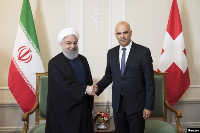 Swiss Federal President Alain Berset and Iranian President Hassan Rouhani shake hands at the beginning of a meeting during Rouhani's official visit to Switzerland in Bern, Switzerland, July 2, 2018.