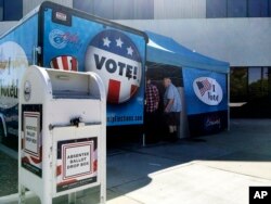 FILE - Idaho voters head to a new food truck-inspired voting unit in Boise, Idaho on Sept. 27, 2016.