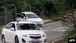 A image shows a blood stained car riddled with bullets (back) following a shoot-out near the Royal Palace in Maseru on Feb. 1, 2015, after the All Basotho Convention (ABC) rally. 