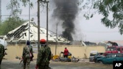 Nigerian soldiers patrol outside the site of an accidental explosion of Boko Haram bombs in Yola, Nigeria, Feb. 25, 2016. 