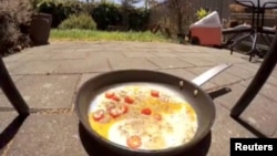 A pan with frying eggs is seen on a pavement during a heat wave in Adelaide, Australia, Jan. 24, 2019, in this picture grab obtained from social media video.