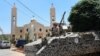 A Lebanese army soldier from the special forces unit stands on a APC during a patrol in front a church in Qaa, a predominantly Lebanese Christian village near the Syrian border were suicide bombers blow themselves among civilians on Monday, eastern Lebano