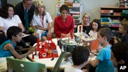 First Lady Melania Trump talks to children as she visits the Necker hospital, France's biggest pediatric hospital in Paris, France, July 13, 2017. 