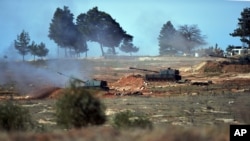 FILE - Turkish artillery fire from the border toward northern Syria, in Kilis, Turkey, Feb. 16, 2016.