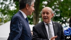 FILE - French Foreign Minister Jean-Yves Le Drian, right, and U.S. Secretary of State Antony Blinken talk during a ceremony at the French ambassador's residence in Washington, July 14, 2021.