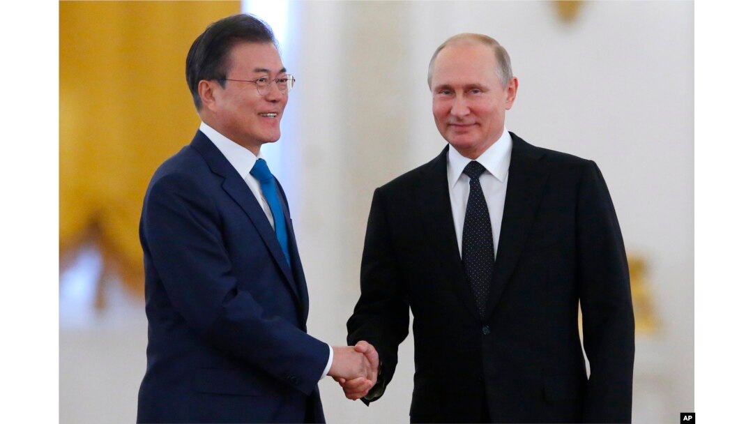 Russian President Vladimir Putin, right, welcomes South Korean President Moon Jae-in prior to their meeting at the Kremlin, in Moscow, Russia, June 22, 2018.