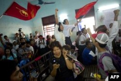Newly-released political student protesters and family members shout and cheer after their release in Tharrawaddy town, Bago Region in Myanmar on April 8, 2016.