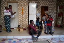 Fallou Diop sits next to his mother Ndeye Boye and his brothers and sister, in Niaga, Rufisque region, Senegal, January 28, 2021. (REUTERS/Zohra Bensemra)