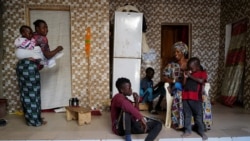 Fallou Diop sits next to his mother Ndeye Boye and his brothers and sister, in Niaga, Rufisque region, Senegal, January 28, 2021. (REUTERS/Zohra Bensemra)