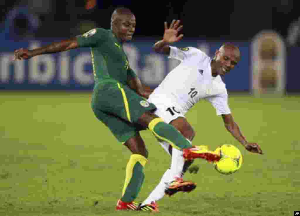 Omar Daf of Senegal (L) challenges Ahmed Saad of Libya during their African Nations Cup Group A soccer match at Estadio de Bata "Bata Stadium", in Bata January 29, 2012.