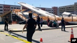 Emergency personnel work at the scene of a collapsed pedestrian bridge at Florida International University on March 15, 2018, in the Miami area. 