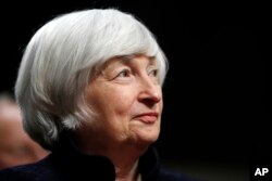 FILE - Federal Reserve Chair Janet Yellen listens to introductions as she is awarded the Paul H. Douglas Award for Ethics in Government, on Capitol Hill in Washington, Nov. 7, 2017.