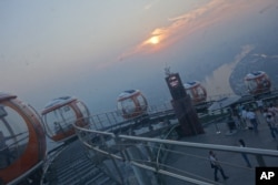 This Oct. 14, 2015 photo was taken inside the bubble tram atop the Canton Tower in Guangzhou, China.