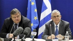 Greek Prime Minister Lucas Papademos, right, and Finance Minister Evangelos Venizelos after a meeting of euro-area finance ministers in Brussels