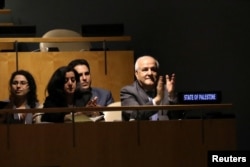 Palestinian Ambassador to the United Nations Riyad Mansour applauds following the adoption of a draft resolution by the United Nations General Assembly to deplore the use of excessive force by Israeli troops against Palestinian civilians at U.N. headquarters in New York, June 13, 2018.