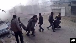 This frame grab from video released by the Syrian Civil Defense White Helmets, which has been authenticated based on its contents and other AP reporting, shows members of the Syrian Civil Defense group and civilians carrying victims after airstrikes hit in Ghouta, a suburb of Damascus, Syria, Thursday, March. 1, 2018. 