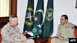 This handout photograph released by Pakistan's Inter Services Public Relations (ISPR) office shows Pakistan's army chief General Ashfaq Kayani (R) as he speaks with US commander in Afghanistan in Rawalpindi, August 2, 2012.