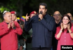 Venezuela's President Nicolas Maduro, meeting with government members, celebrates the ruling Socialist Party winning more governorships, in Caracas. Oct. 15, 2017.