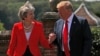 FILE - Britain's Prime Minister Theresa May and U.S. President Donald Trump walk to a joint news conference at Chequers, the official country residence of the prime minister, near Aylesbury, Britain, July 13, 2018.