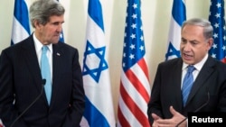 U.S. Secretary of State John Kerry listens as Israeli Prime Minister Benjamin Netanyahu makes a statement to the press before a meeting in Jerusalem on January 2, 2014.