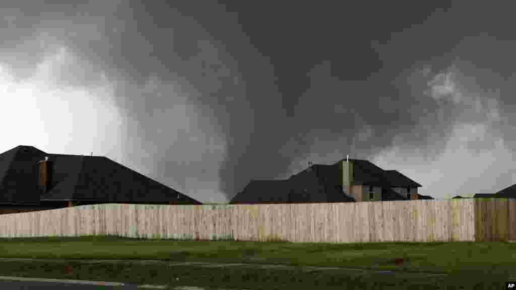 A tornado moves past homes in Moore, Oklahoma, May 20, 2013.