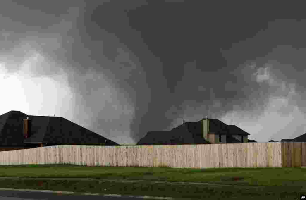 A tornado moves past homes in Moore, Oklahoma, May 20, 2013.