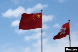 A Chinese national flag and a Hong Kong flag fly outside the Legislative Council in Hong Kong, China November 7, 2016, as China's parliament passed an interpretation of Hong Kong's Basic Law on Monday that says lawmakers must swear allegiance to the city