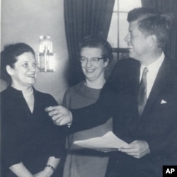 Nancy Grace Roman, center, with President John F. Kennedy in the Oval Office at the White House in 1962.