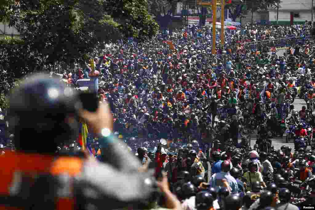 Thousands of motorcyclists drive during a protest against a measure to combat insecurity in Caracas, Venezula. Authorities imposed a night ban in a bid to curb crimes. Officials in Caracas and other areas made it illegal to ride a motorcycle after 9pm.