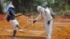 FILE - A man is sprayed with disinfectant after he celebrated the memory of a loved one who died due to the Ebola virus at a newly build grave yard for Ebola virus victims in Monrovia, Liberia, Wednesday, March 11, 2015. Liberians held a church service Wednesday