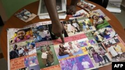 Toyin Lolu-Ogunmade, the founder of the agency Precious Conceptions, which helps women with fertility problems, shows pictures of her family in her office in Lagos on Dec. 12, 2018. 
