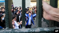 FILE - In a photo, taken by an individual not employed by the Associated Press and obtained by the AP outside Iran, university students attend an anti-government protest inside Tehran University, in Tehran, Iran, Dec. 30, 2017. 